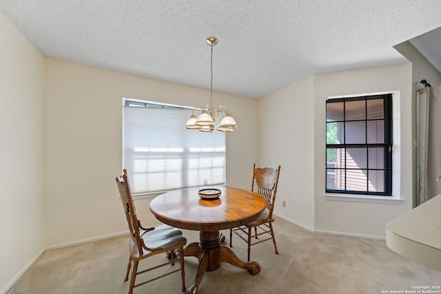 10955 Wurzbach Unit 905, San Antonio, TX 78230 - carpeted dining room featuring a textured ceiling, a chandelier, and baseboards