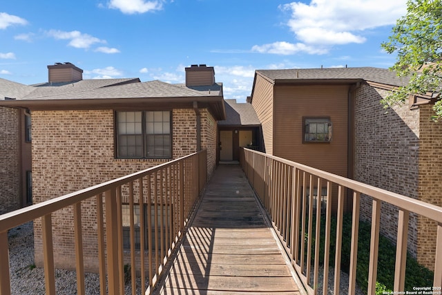 10955 Wurzbach Unit 905, San Antonio, TX 78230 - rear view of house with brick siding, a chimney, and a shingled roof