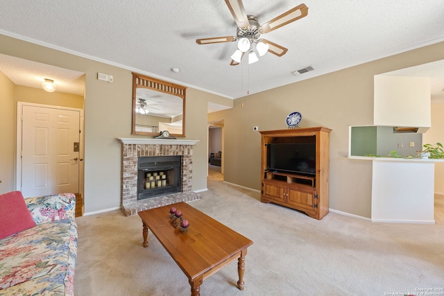 10955 Wurzbach Unit 905, San Antonio, TX 78230 - carpeted living area with a ceiling fan, crown molding, a textured ceiling, baseboards, and a fireplace