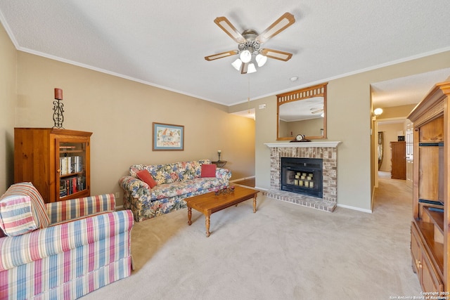 10955 Wurzbach Unit 905, San Antonio, TX 78230 - carpeted living room featuring ceiling fan, ornamental molding, a fireplace, a textured ceiling, and baseboards