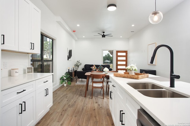 321 Porter St, San Antonio, TX 78210 - kitchen featuring a sink, light countertops, light wood-style flooring, ceiling fan, and healthy amount of natural light