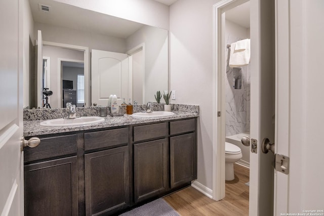 9123 Bennett Frst, Converse, TX 78109 - bathroom with toilet, double vanity, wood finished floors, and a shower