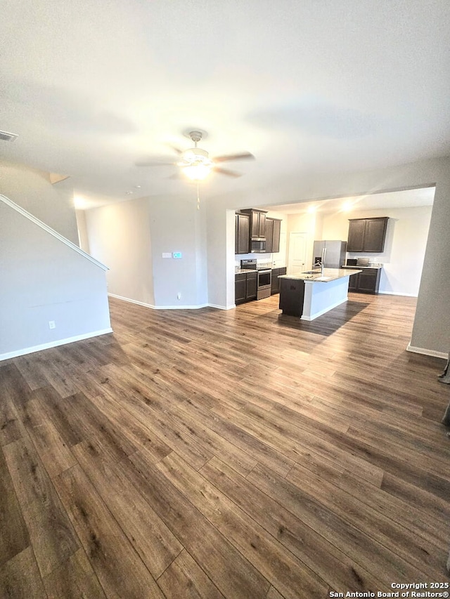 9123 Bennett Frst, Converse, TX 78109 - unfurnished living room featuring dark wood-style flooring, ceiling fan, and baseboards