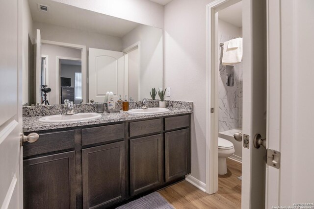 9123 Bennett Frst, Converse, TX 78109 - bathroom with toilet, double vanity, wood finished floors, and a shower