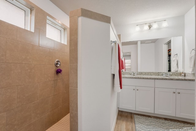 6022 Akin Pl, San Antonio, TX 78261 - bathroom featuring double vanity, walk in shower, and wood finished floors