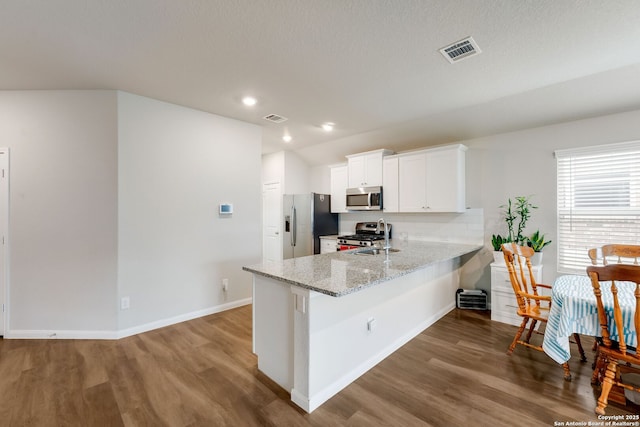 6022 Akin Pl, San Antonio, TX 78261 - kitchen featuring stainless steel appliances, wood finished floors, white cabinets, light stone counters, and recessed lighting