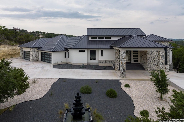 25003 Miranda Rdg, Boerne, TX 78006 - back of house with stucco siding, a garage, driveway, and a standing seam roof