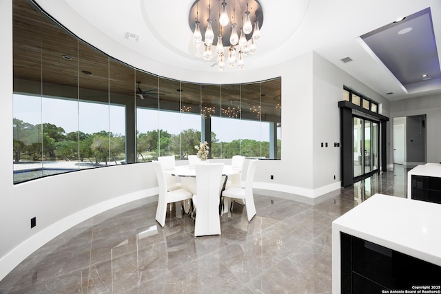 25003 Miranda Rdg, Boerne, TX 78006 - dining space featuring baseboards, light marble finish flooring, a raised ceiling, and a chandelier