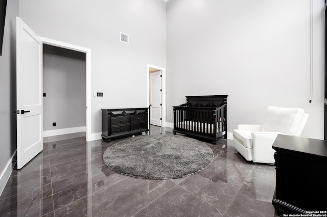 25003 Miranda Rdg, Boerne, TX 78006 - bedroom featuring marble tiled floors, a towering ceiling, and baseboards