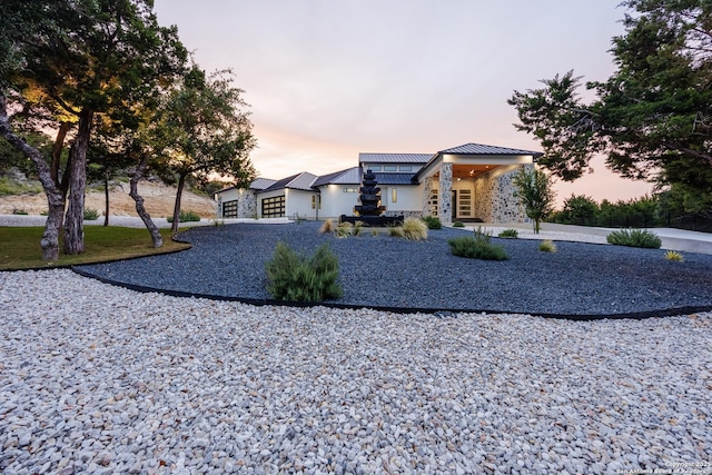 25003 Miranda Rdg, Boerne, TX 78006 - contemporary home featuring a standing seam roof, stone siding, and metal roof