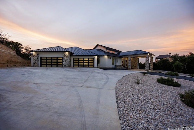 25003 Miranda Rdg, Boerne, TX 78006 - contemporary house featuring a garage, stone siding, a standing seam roof, and concrete driveway