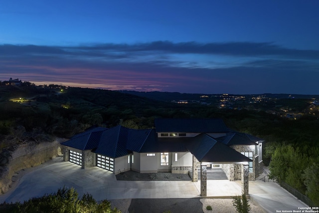 25003 Miranda Rdg, Boerne, TX 78006 - view of front of home featuring concrete driveway, stone siding, a garage, and metal roof