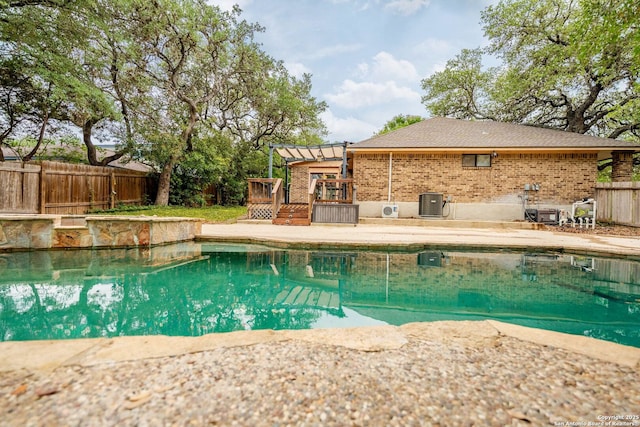 19739 Encino Way, San Antonio, TX 78259 - view of pool with a wooden deck, a fenced backyard, a pergola, and central AC