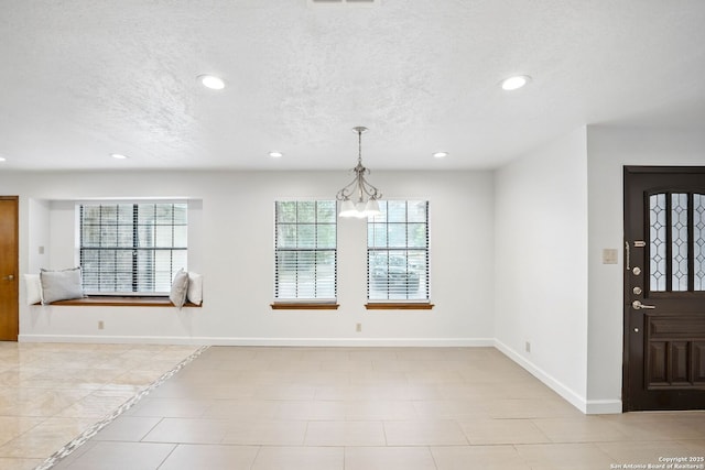 19739 Encino Way, San Antonio, TX 78259 - entryway with recessed lighting, a textured ceiling, baseboards, and a chandelier