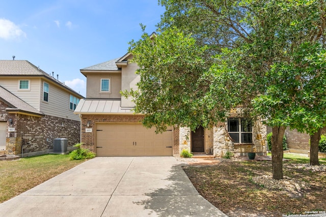 6031 Diego, San Antonio, TX 78253 - view of front of house featuring a standing seam roof, concrete driveway, brick siding, central AC unit, and an attached garage