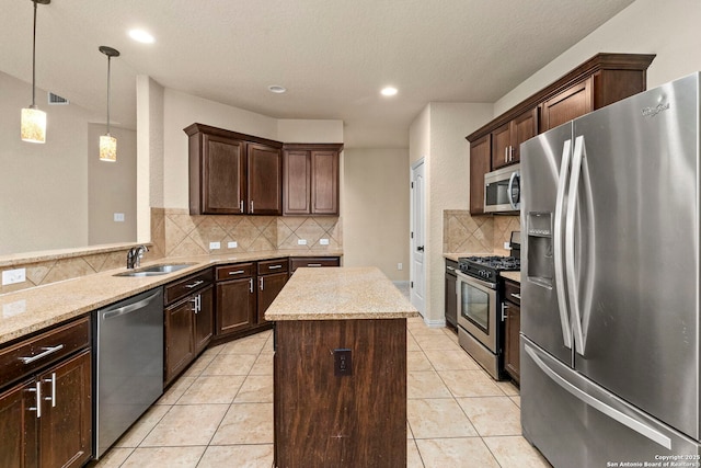 6031 Diego, San Antonio, TX 78253 - kitchen featuring appliances with stainless steel finishes, a sink, backsplash, a kitchen island, and dark brown cabinetry