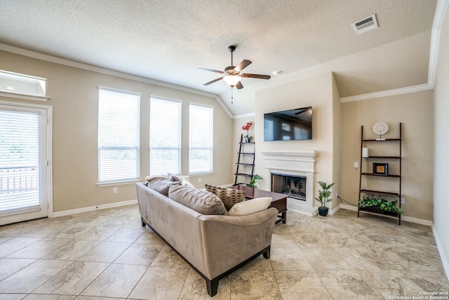 4522 Amos Pollard, San Antonio, TX 78253 - living room featuring crown molding, ceiling fan, a fireplace with raised hearth, a textured ceiling, and baseboards