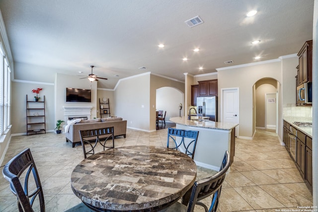 4522 Amos Pollard, San Antonio, TX 78253 - dining space with arched walkways, a ceiling fan, a fireplace, recessed lighting, and baseboards