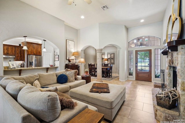 2756 Indian Wls, Kerrville, TX 78028 - living room with light tile patterned floors, arched walkways, a ceiling fan, a high ceiling, and ornate columns
