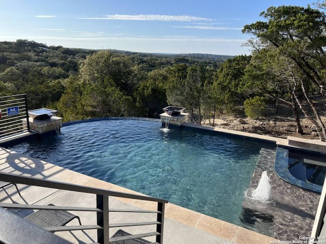 239 Damar Cv, Canyon Lake, TX 78133 - view of pool with an infinity pool and a wooded view