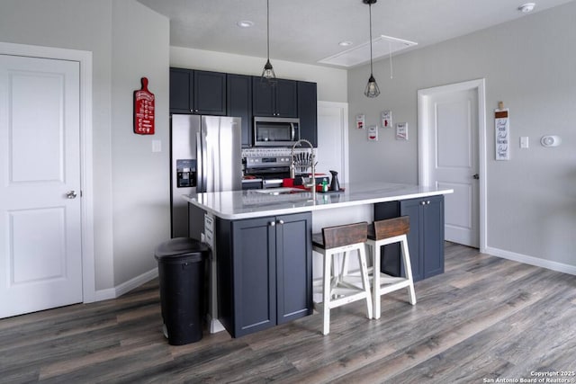239 Damar Cv, Canyon Lake, TX 78133 - kitchen with appliances with stainless steel finishes, baseboards, light countertops, dark wood finished floors, and recessed lighting