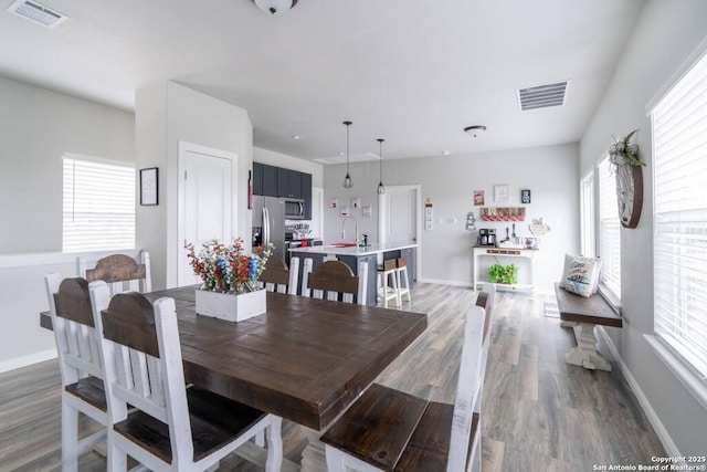 239 Damar Cv, Canyon Lake, TX 78133 - dining room with wood finished floors, healthy amount of natural light, and baseboards