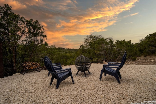 239 Damar Cv, Canyon Lake, TX 78133 - yard at dusk featuring a fire pit