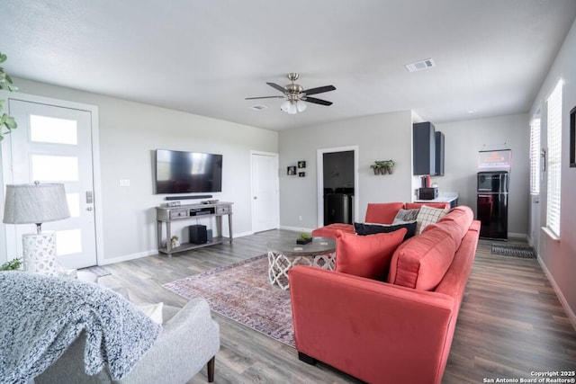 239 Damar Cv, Canyon Lake, TX 78133 - living room featuring baseboards, wood finished floors, and a ceiling fan