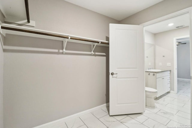 4526 Meadowland, San Antonio, TX 78222 - spacious closet featuring a sink and light marble finish floors