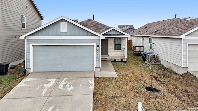 4526 Meadowland, San Antonio, TX 78222 - view of front facade with driveway, board and batten siding, an attached garage, and a shingled roof