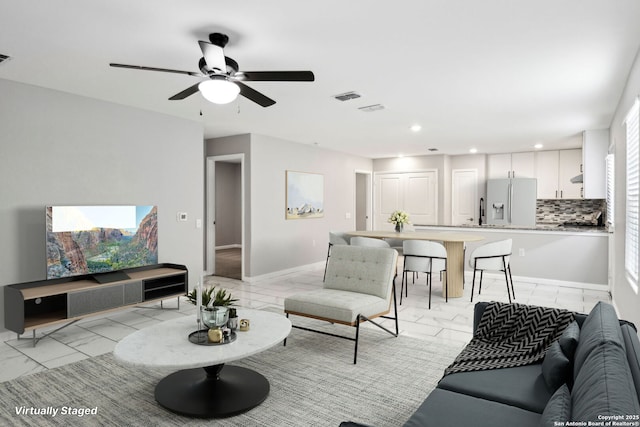 4526 Meadowland, San Antonio, TX 78222 - living room featuring light marble finish floors, recessed lighting, a ceiling fan, and baseboards