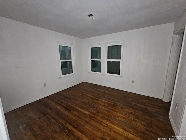 303 Cravens, San Antonio, TX 78223 - unfurnished room with dark wood-style floors and baseboards