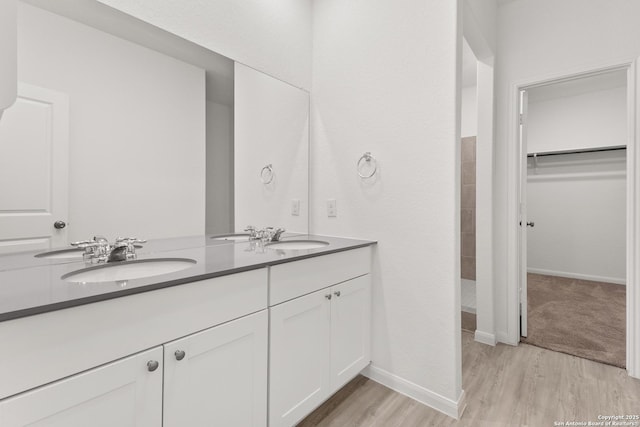 31908 Native Sun, Bulverde, TX 78163 - full bathroom with double vanity, wood finished floors, a spacious closet, and baseboards
