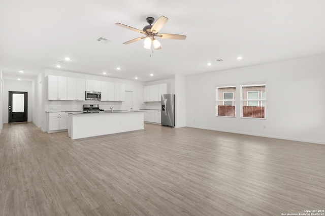 31908 Native Sun, Bulverde, TX 78163 - unfurnished living room featuring light wood-type flooring, a ceiling fan, recessed lighting, baseboards, and a sink