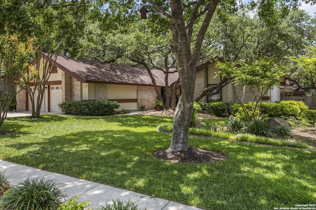 4722 Paradise Woods, San Antonio, TX 78249 - view of front of home with brick siding, a front yard, and a garage