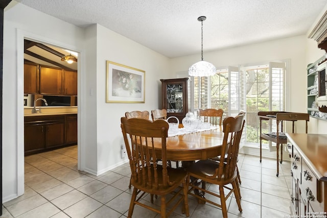 4722 Paradise Woods, San Antonio, TX 78249 - dining area featuring light tile patterned flooring, a textured ceiling, and baseboards