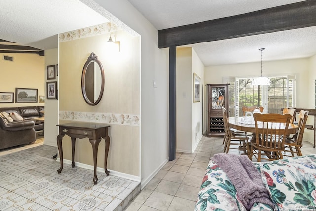 4722 Paradise Woods, San Antonio, TX 78249 - living area featuring a textured ceiling, light tile patterned flooring, beam ceiling, and baseboards