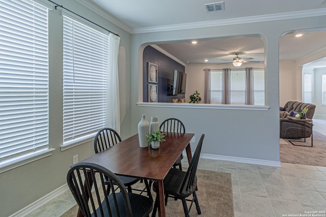 15166 Orpheus Way, San Antonio, TX 78245 - dining area with baseboards, a ceiling fan, crown molding, recessed lighting, and arched walkways