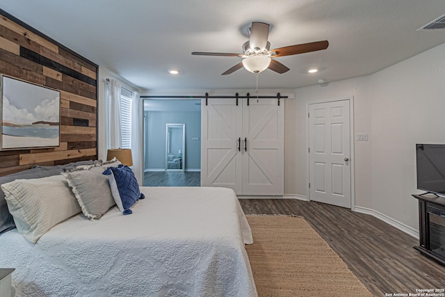 15166 Orpheus Way, San Antonio, TX 78245 - bedroom with wood finished floors, baseboards, a barn door, recessed lighting, and ceiling fan
