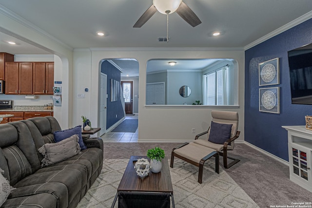 15166 Orpheus Way, San Antonio, TX 78245 - living area featuring arched walkways, a ceiling fan, crown molding, baseboards, and light colored carpet