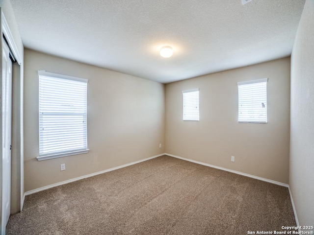 7010 Aphrodite Mist, San Antonio, TX 78252 - spare room with carpet flooring, baseboards, and a textured ceiling