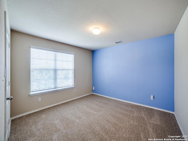 7010 Aphrodite Mist, San Antonio, TX 78252 - spare room featuring carpet flooring, a textured ceiling, and baseboards