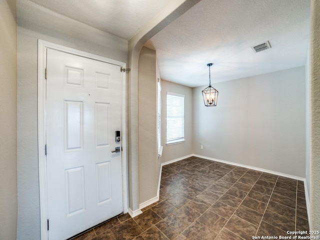 7010 Aphrodite Mist, San Antonio, TX 78252 - entryway with baseboards, a chandelier, and arched walkways