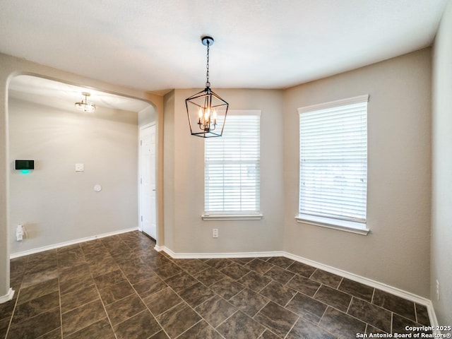 7010 Aphrodite Mist, San Antonio, TX 78252 - empty room with a chandelier, baseboards, and arched walkways