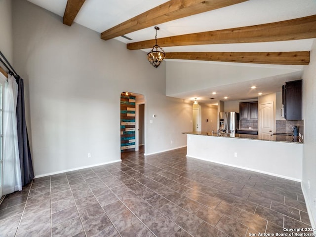 7010 Aphrodite Mist, San Antonio, TX 78252 - unfurnished living room featuring arched walkways, baseboards, high vaulted ceiling, beam ceiling, and recessed lighting
