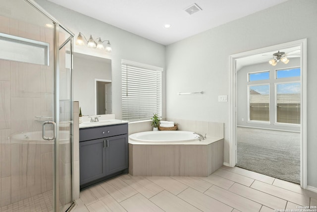 9304 Aggie Run, San Antonio, TX 78254 - bathroom featuring vanity, a shower stall, a garden tub, tile patterned floors, and ceiling fan
