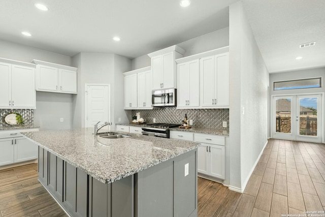 9304 Aggie Run, San Antonio, TX 78254 - kitchen featuring a sink, appliances with stainless steel finishes, a kitchen island with sink, white cabinets, and recessed lighting