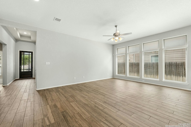 9304 Aggie Run, San Antonio, TX 78254 - unfurnished living room featuring a ceiling fan, wood finished floors, and baseboards
