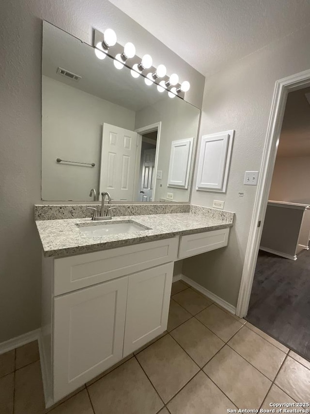 2606 Montebello, San Antonio, TX 78259 - bathroom featuring tile patterned floors, vanity, and baseboards