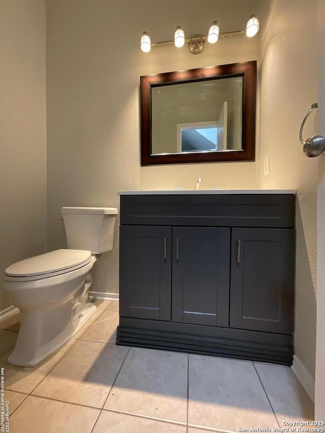 2606 Montebello, San Antonio, TX 78259 - half bathroom with vanity, baseboards, tile patterned floors, and toilet